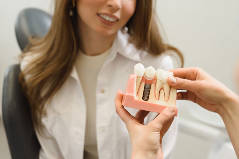 Dental Patient Getting Shown A Dental Implant Model During Her Consultation in Harrisonburg, VA